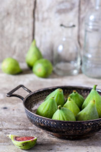 Rustic still life with fresh green figs on wood Rustic still life with fresh green figs on wood